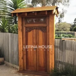 Pintu gebyok Bali dari kayu jati solid dengan ukiran khas dan finishing melamine natural klasik